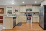 Fully equipped kitchen w laminated wood flooring